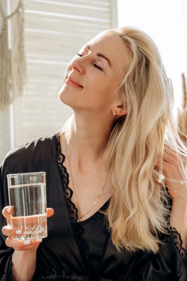 a-young-blonde-woman-drinks-water-from-a-glass-sit-2026-01-07-01-36-15-utc water softening systems